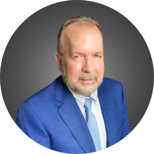 Close up headshot image of Mark Witaschek in a suit