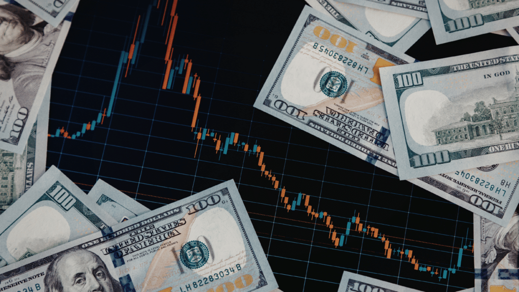 Stock market graph and 100 dollar bills laid out